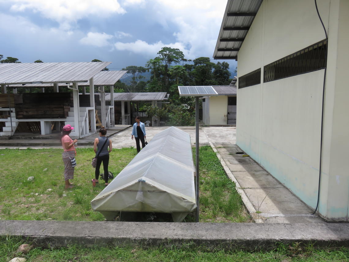 University of Calgary students Cristina Vallejo, Andria Panidisz and Jullian Haneiph assess the Wiñak Association dryer system as part of a project to determine the feasibility of using solar power to dry cacao in Santa Rita, Ecuador.